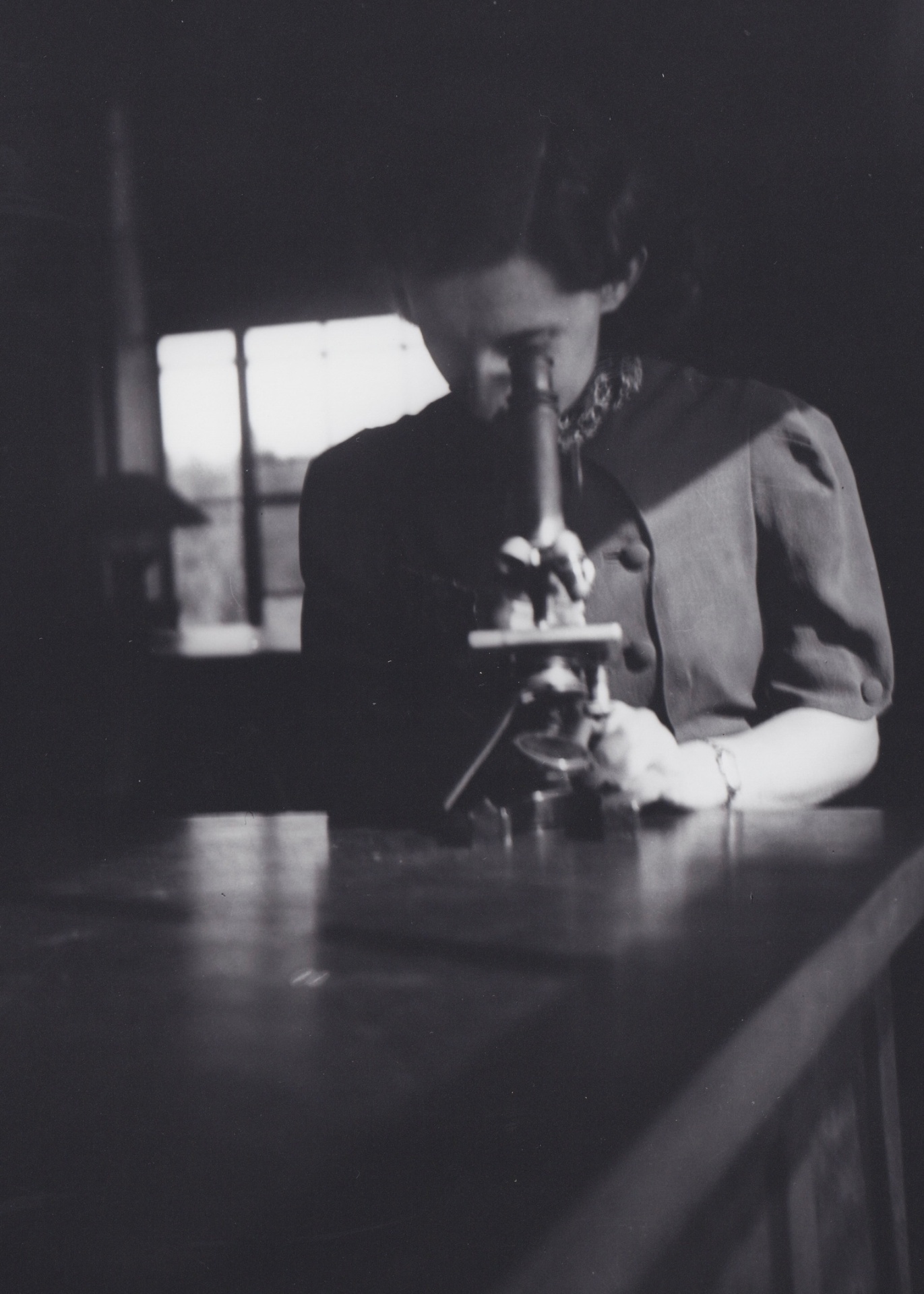Dr. Myrtle Logan at a microscope