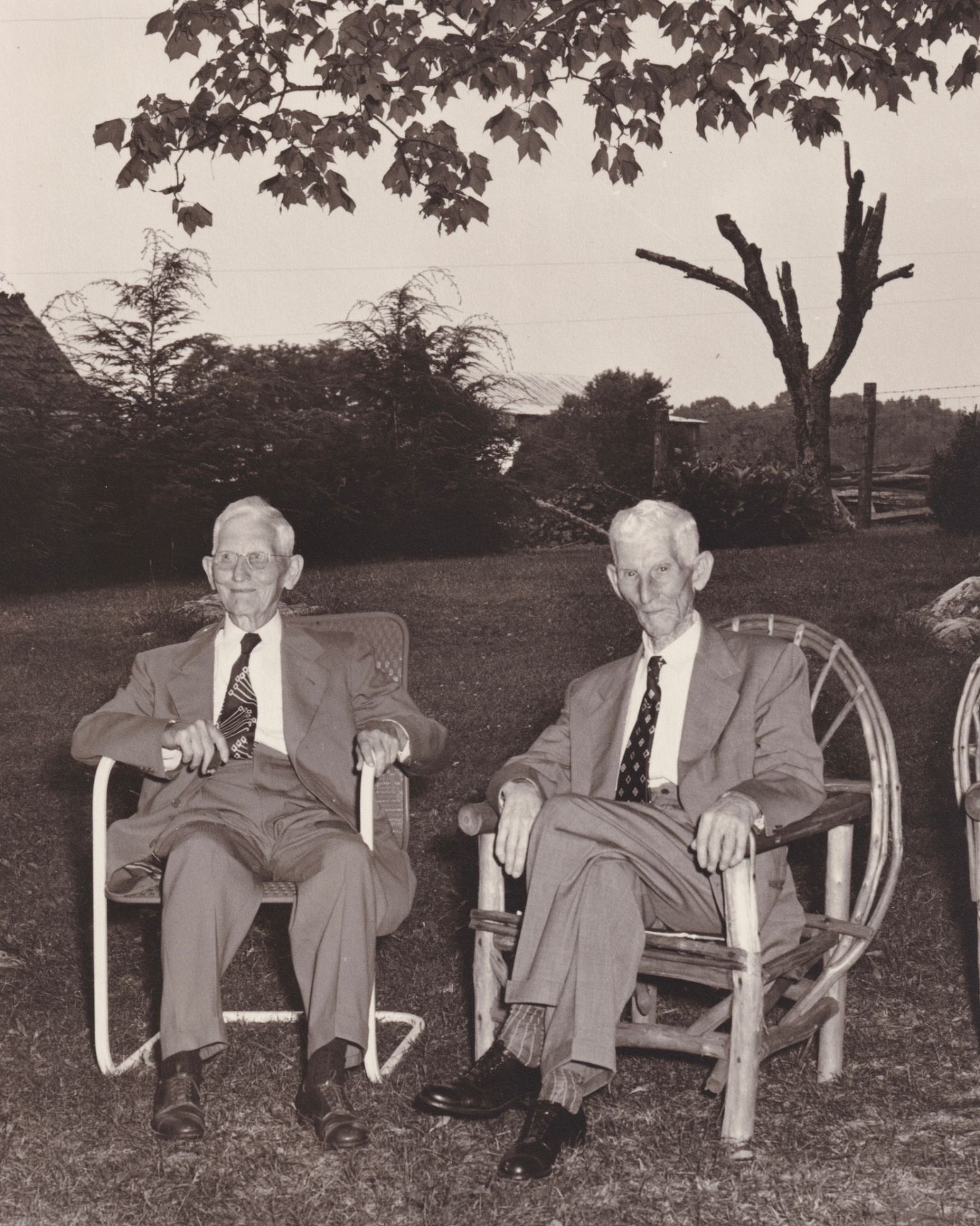 Tom Logan and Toad Logan seated together on the farm